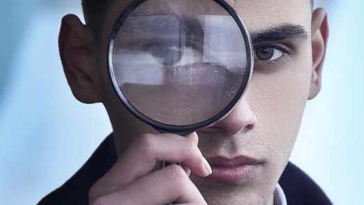 Man holding magnifying glass