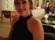 smiling young woman wear a black dress at a fancy event