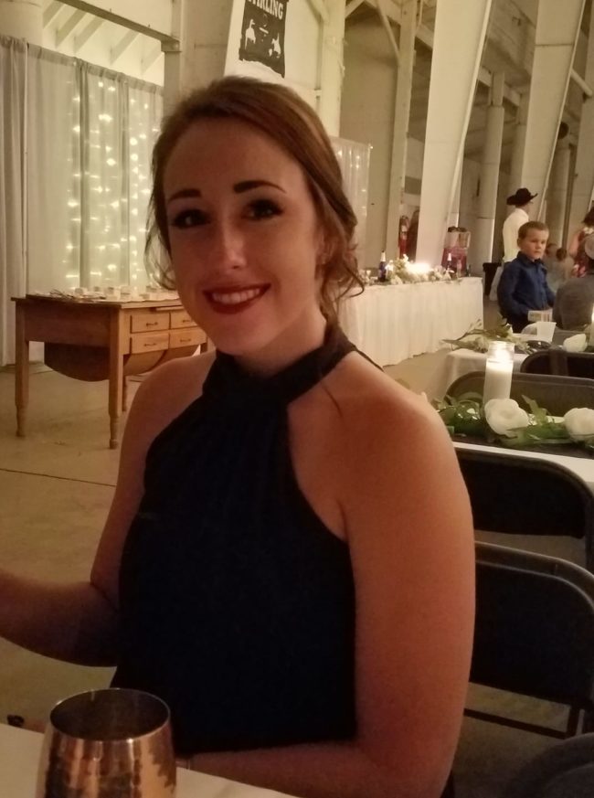 smiling young woman wear a black dress at a fancy event