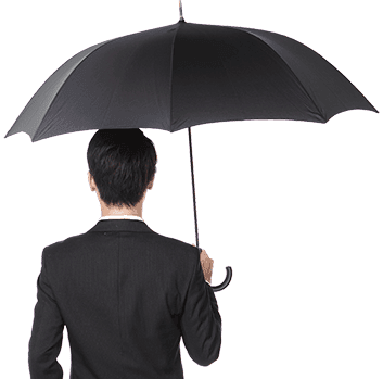 Back view of a man in a black suit holding a large black umbrella.